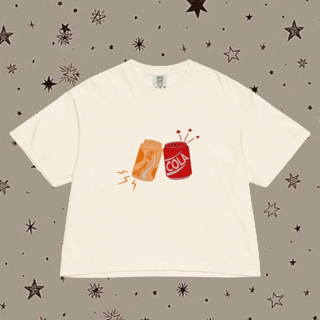 White t-shirt with graphic design on a patterned background