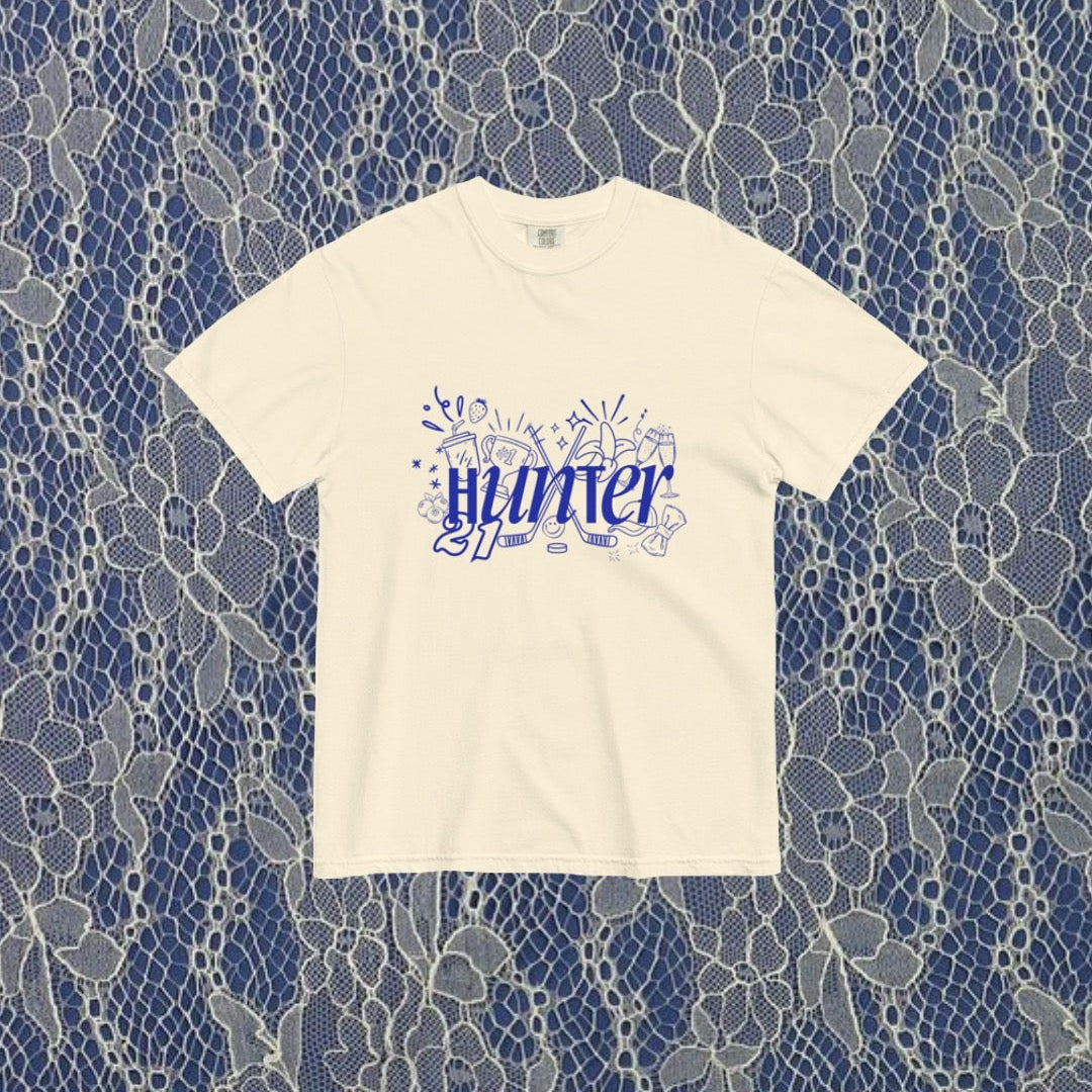 White t-shirt with blue text on a lace pattern background