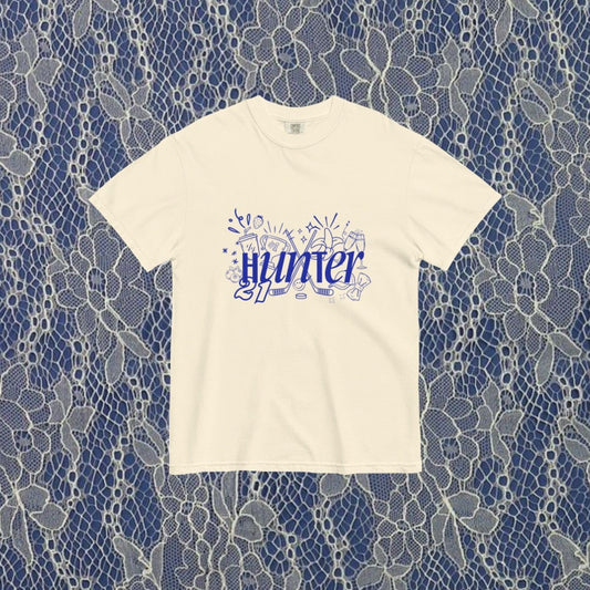 White t-shirt with blue text on a lace pattern background