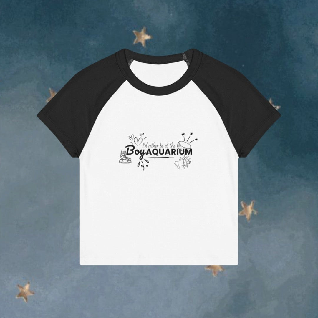 White t-shirt with black sleeves on a blue background with star shapes