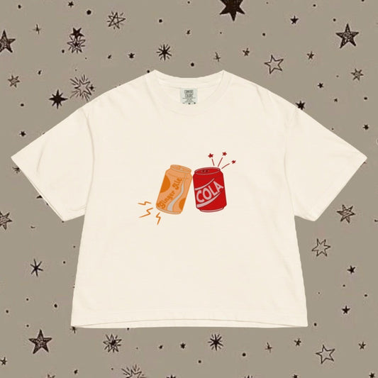 White t-shirt with graphic design on a patterned background