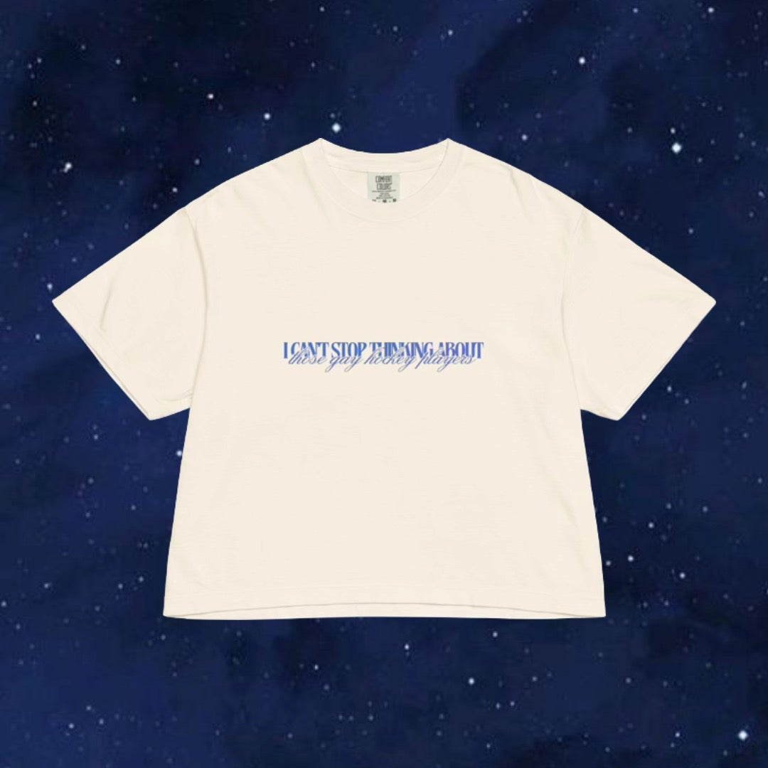 Beige t-shirt with text on a dark blue starry background