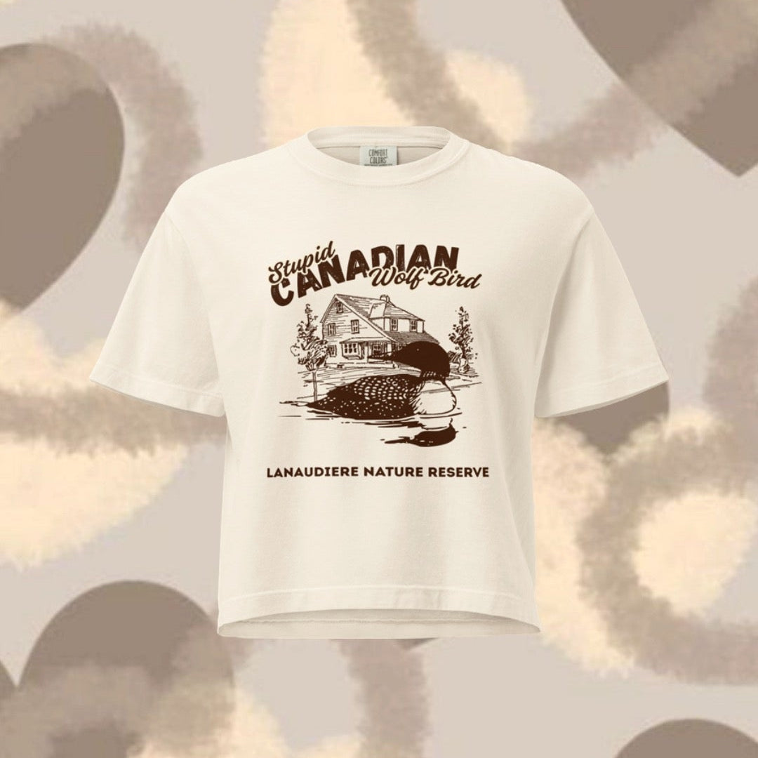 White t-shirt with graphic design on a patterned background